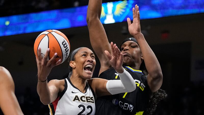 Las Vegas Aces forward A'ja Wilson (22) makes a move to the basket as Dallas Wings center...