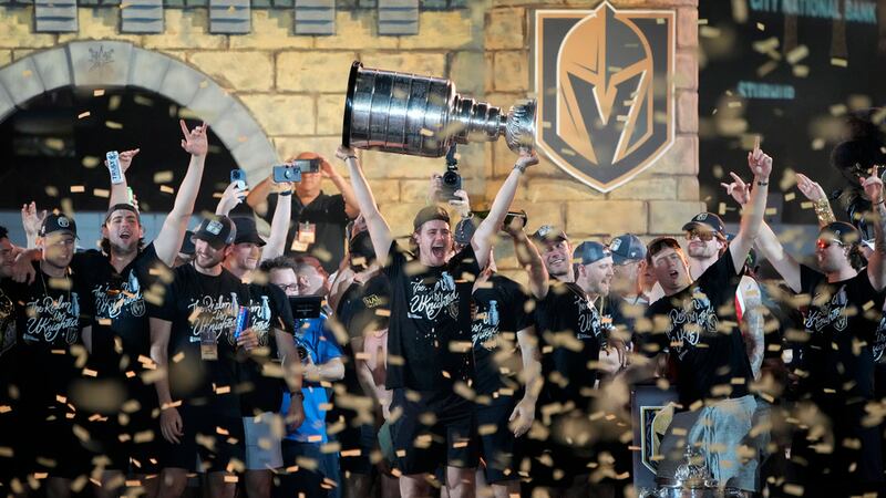 Vegas Golden Knights celebrate with the Stanley Cup during a rally after a parade along the...