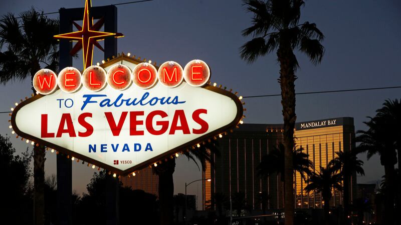 FILE - In this Sept. 21, 2018, file photo, the Mandalay Bay hotel and casino reflects the last...