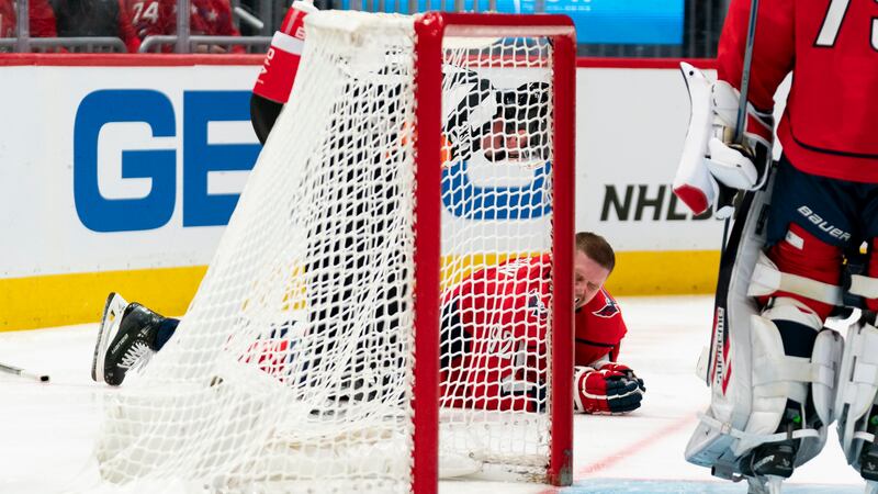 Washington Capitals center Evgeny Kuznetsov reacts after a hit to the head in the second...