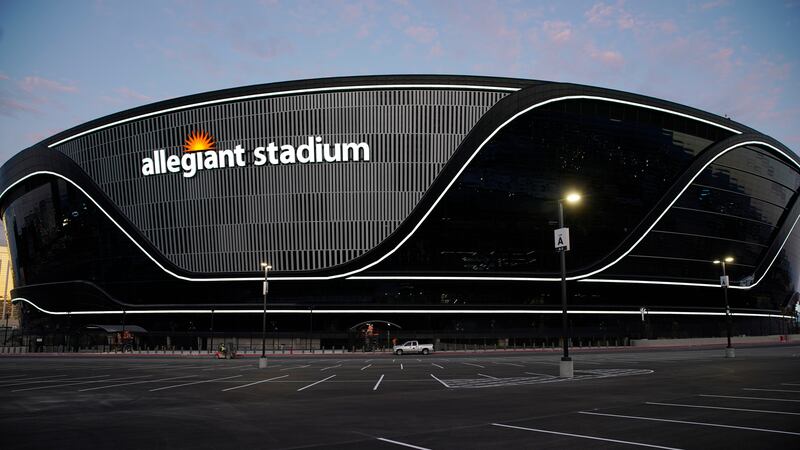 Lights adorn Allegiant Stadium, new home of the Las Vegas Raiders football team, as it nears...
