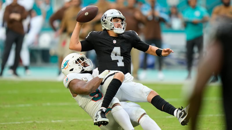 Miami Dolphins defensive tackle Christian Wilkins (94) takes down Las Vegas Raiders...