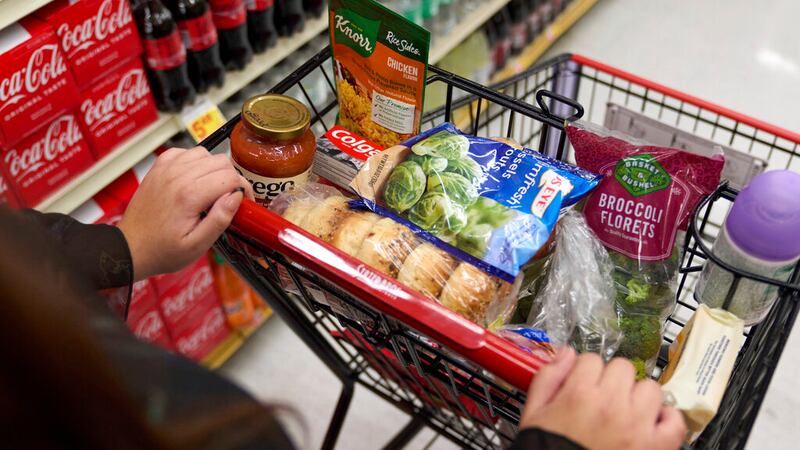 Jaqueline Benitez, who depends on California's SNAP benefits to help pay for food, shops for...