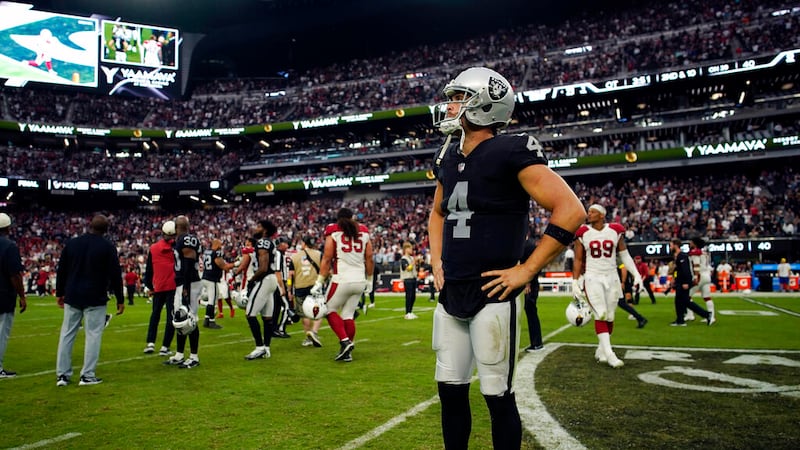 Las Vegas Raiders quarterback Derek Carr (4) stands on the field after an overtime loss to the...