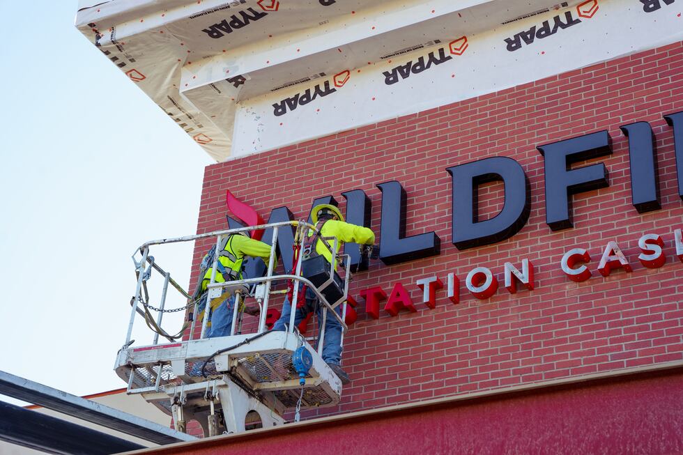 Crew members putting the finishing touches on the exterior signage of the casino on Tuesday,...