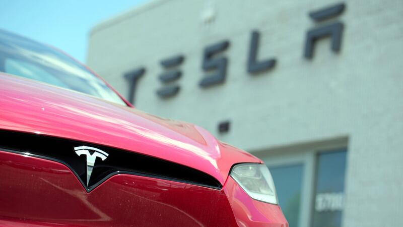 An unsold 2023 Model X sports-utility vehicle sits outside a Tesla dealership Sunday, June 18,...