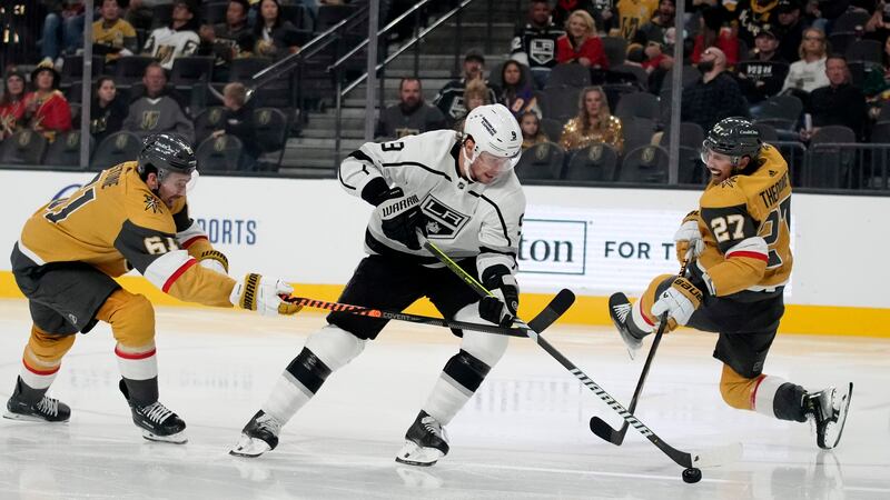 Vegas Golden Knights right wing Mark Stone (61) commits a hooking penalty on Los Angeles Kings...
