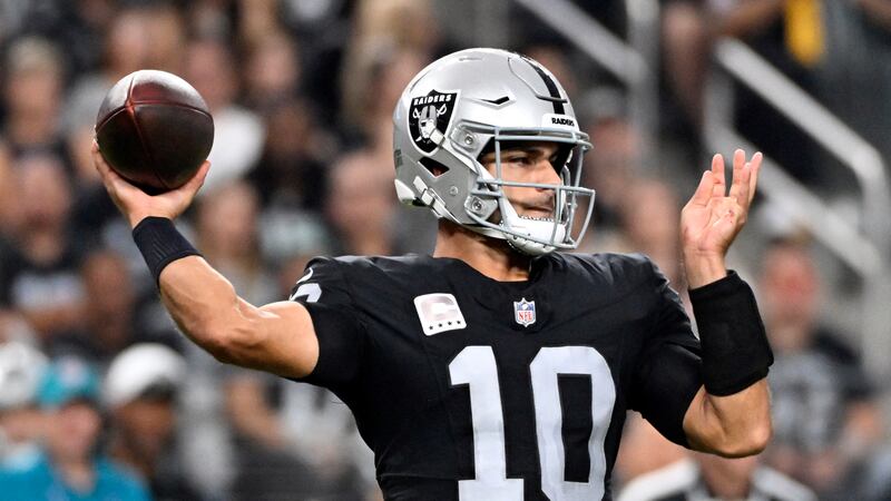 Las Vegas Raiders quarterback Jimmy Garoppolo throws during the first half of an NFL football...