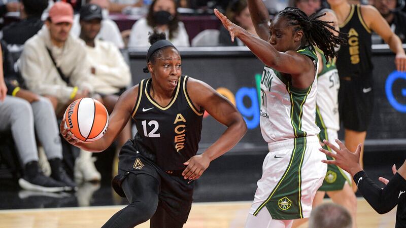 Las Vegas Aces guard Chelsea Gray (12) passes around Seattle Storm's Tina Charles during the...