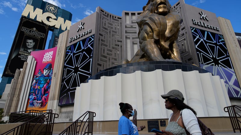 People walk by the MGM Grand hotel-casino Wednesday, Sept. 13, 2023, in Las Vegas. A...