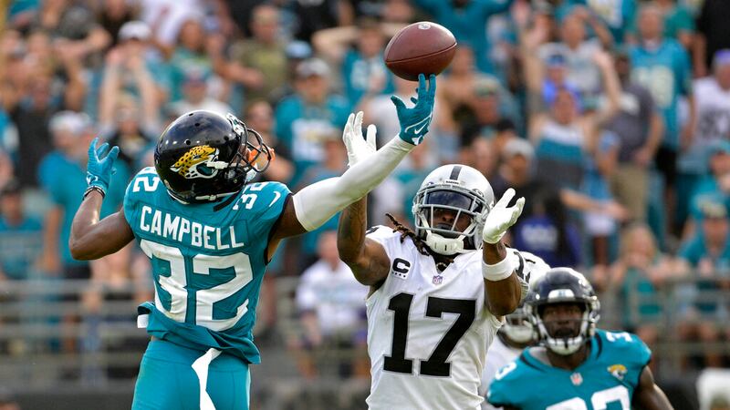Jacksonville Jaguars cornerback Tyson Campbell (32) breaks up a pass intended for Las Vegas...