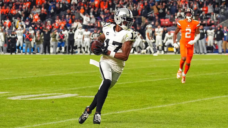 Las Vegas Raiders wide receiver Davante Adams (17) runs toward the end zone in front of Denver...
