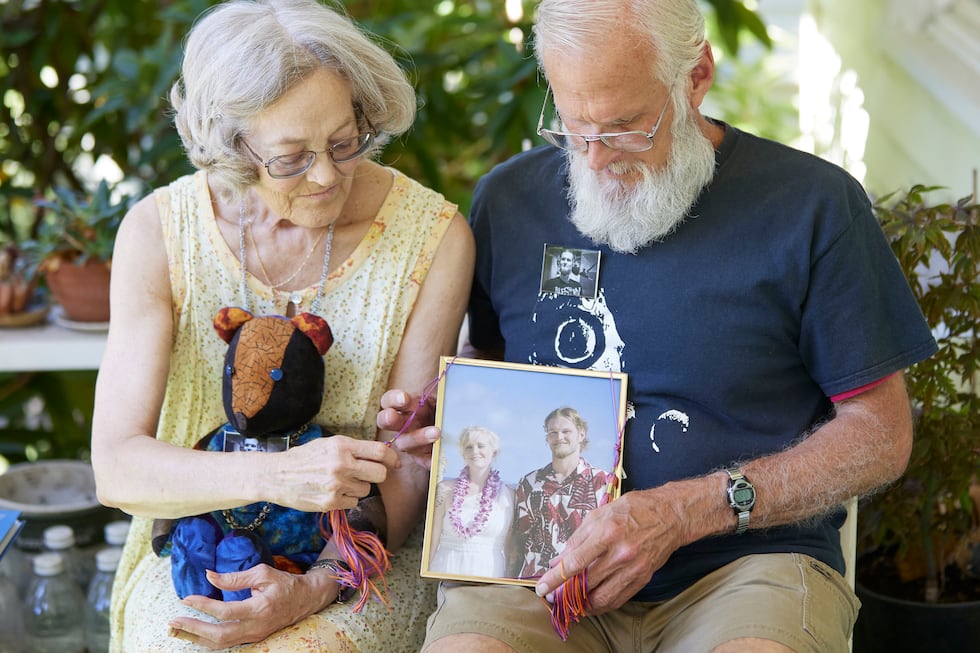 George, right, and Carolyn Spaulding hold an old family photo showing their son, Brian, in...